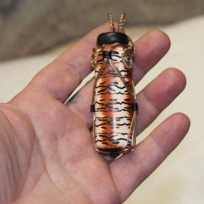 tiger bottle shown with hand for size