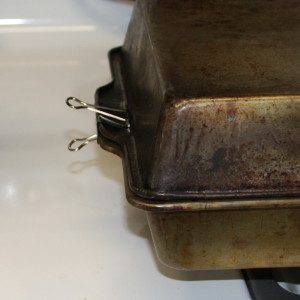 metal clips hold 2 pans together