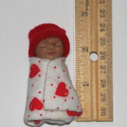 Valentine Baby doll next to ruler