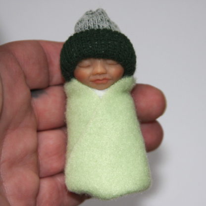 green baby doll bundle in hand