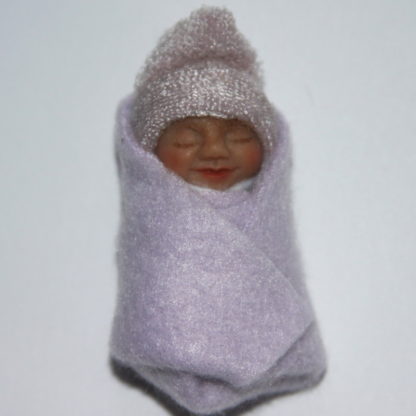 Miniature baby in lavender fleece