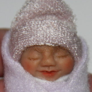 Miniature baby doll face