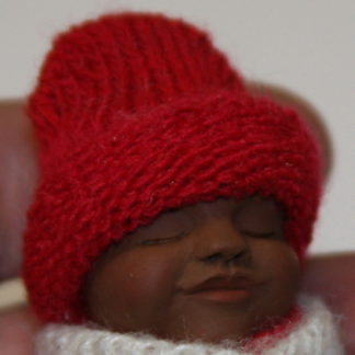 african baby boy doll side face