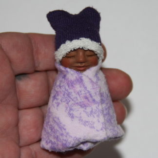 Mexican/ African baby girl doll in hand