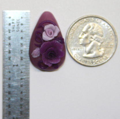 Purple lavender Roses cabochon next to ruler