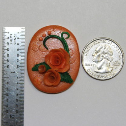 Pumpkin Orange Roses Pendant next to ruler