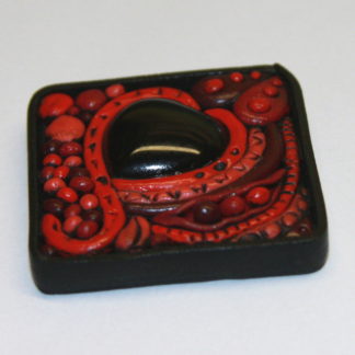 Black Onyx Heart in red abstract clay pendant
