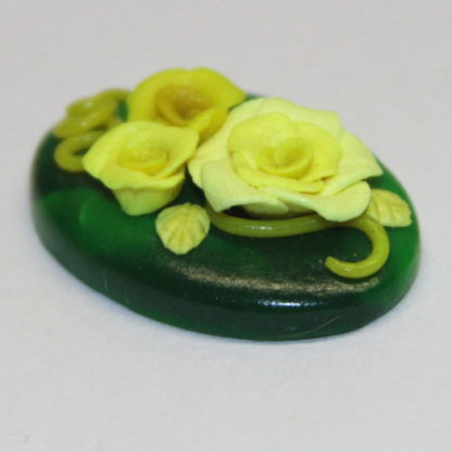 3 dimensional yellow roses on Green Polymer clay pendant