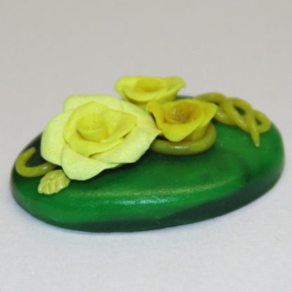 3 dimensional yellow roses on Green cabochon