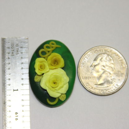 3 dimensional yellow roses on Green Cabochon with ruler