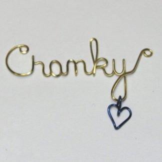 Cranky written in brass wire with purple dangling heart