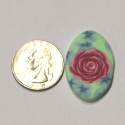 Pink Rose Mint Green Pendant next to ruler