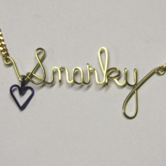 snarky written in wire with dangling purple heart
