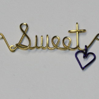 Sweet written in brass wire with a dangling heart
